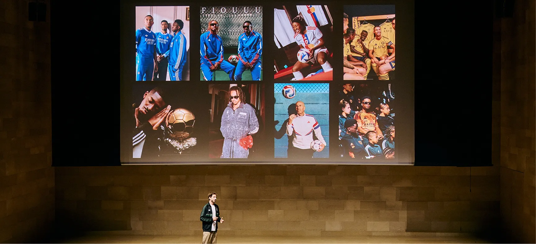 Presenter on stage with soccer image collage