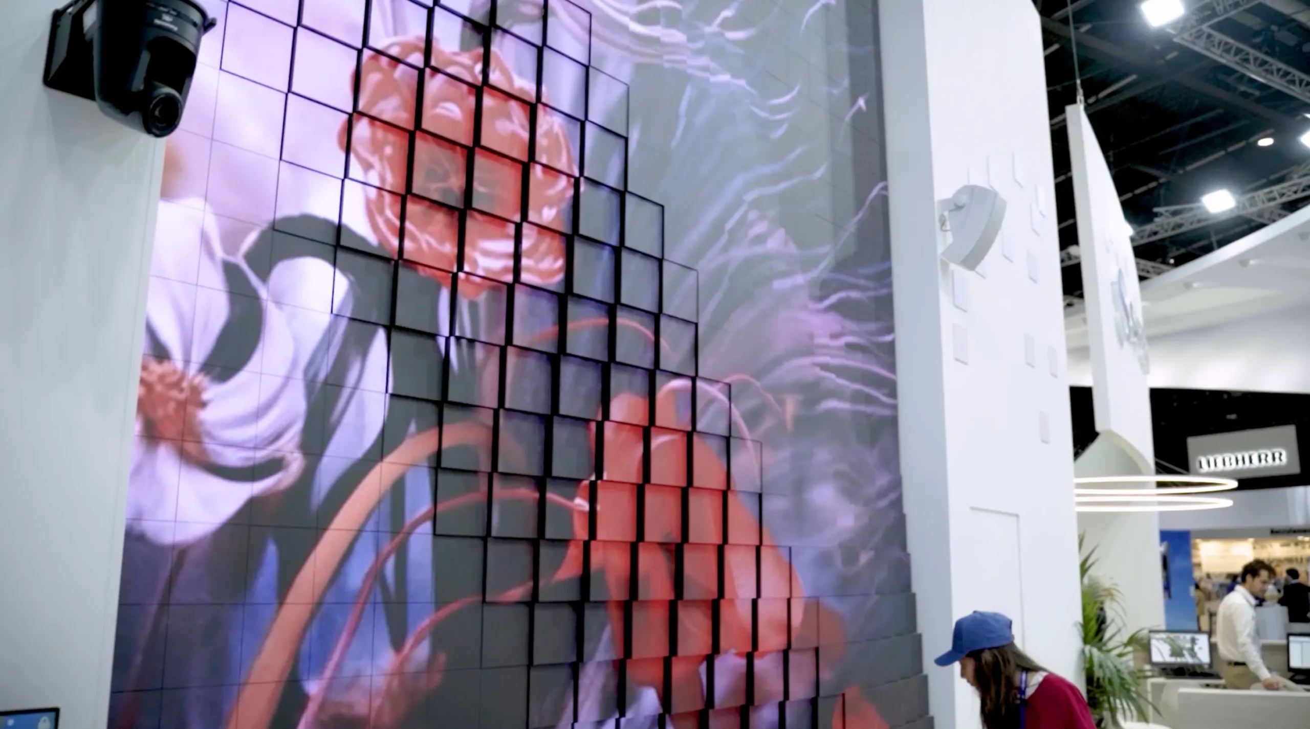Large tiled digital art display at exhibition booth