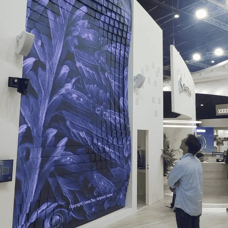 Man viewing large blue digital art wall